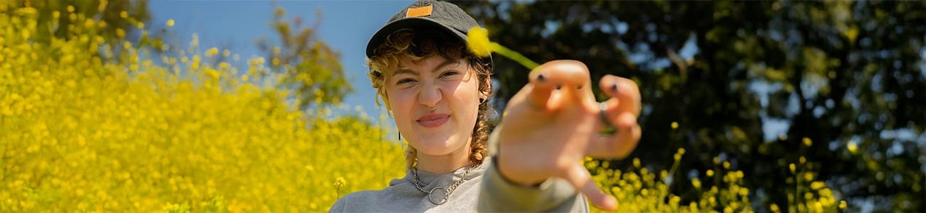 Individual_Therapy_Header Photo of a person holding a flower in nature